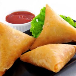 Aloo Cone Samosas served with ketchup.