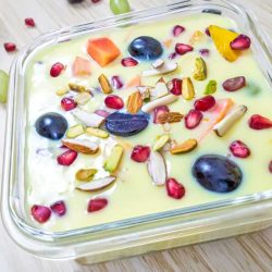 Fruit Custard garnished with different fruits.